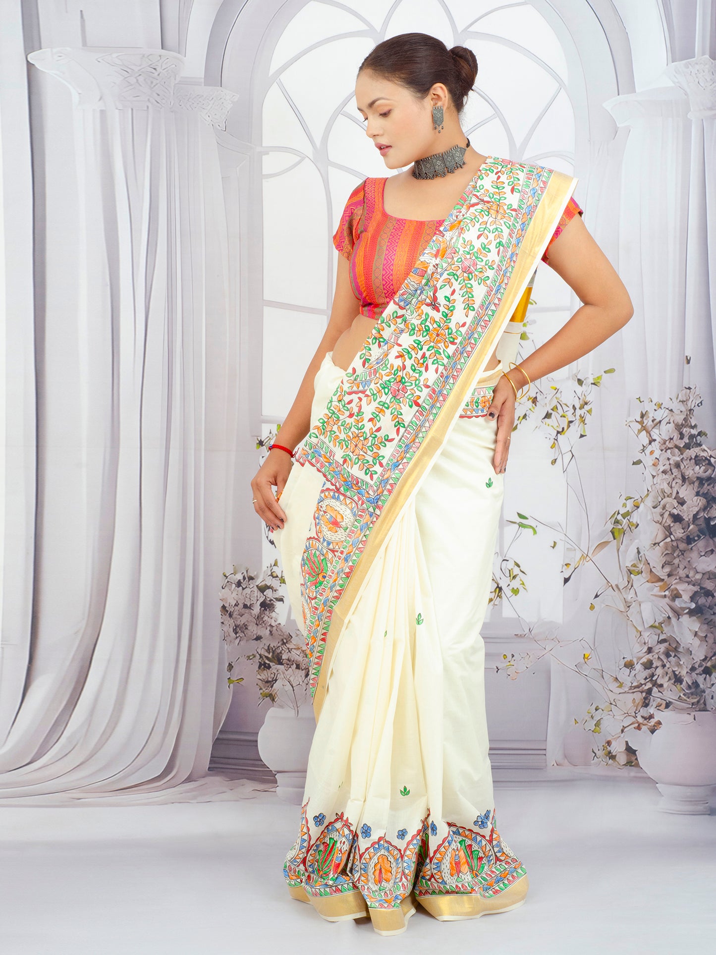 Floral Madhubani hand-painted Kerala cotton saree displayed on a mannequin