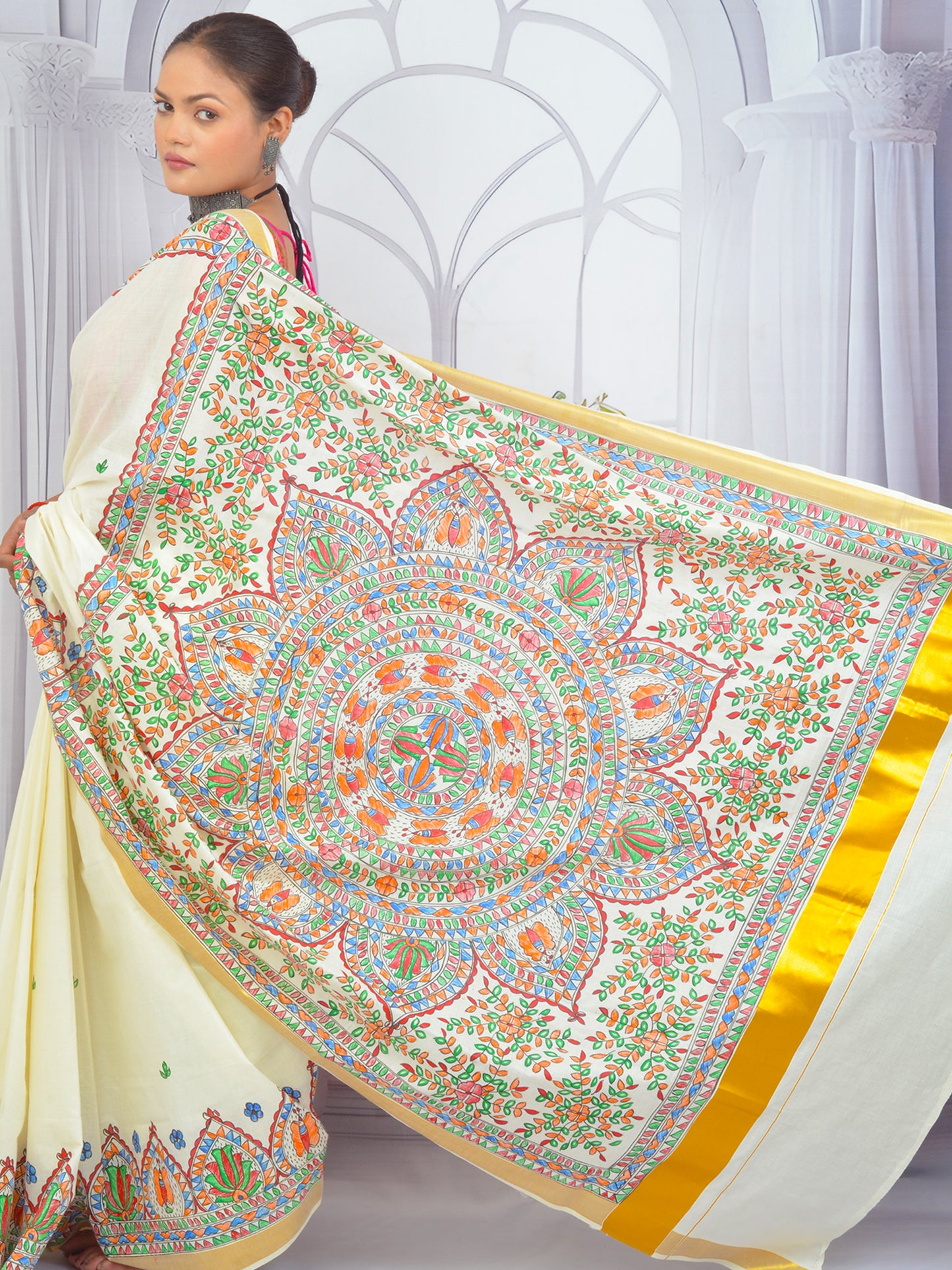 Close-up of floral Madhubani artwork on white Kerala cotton saree