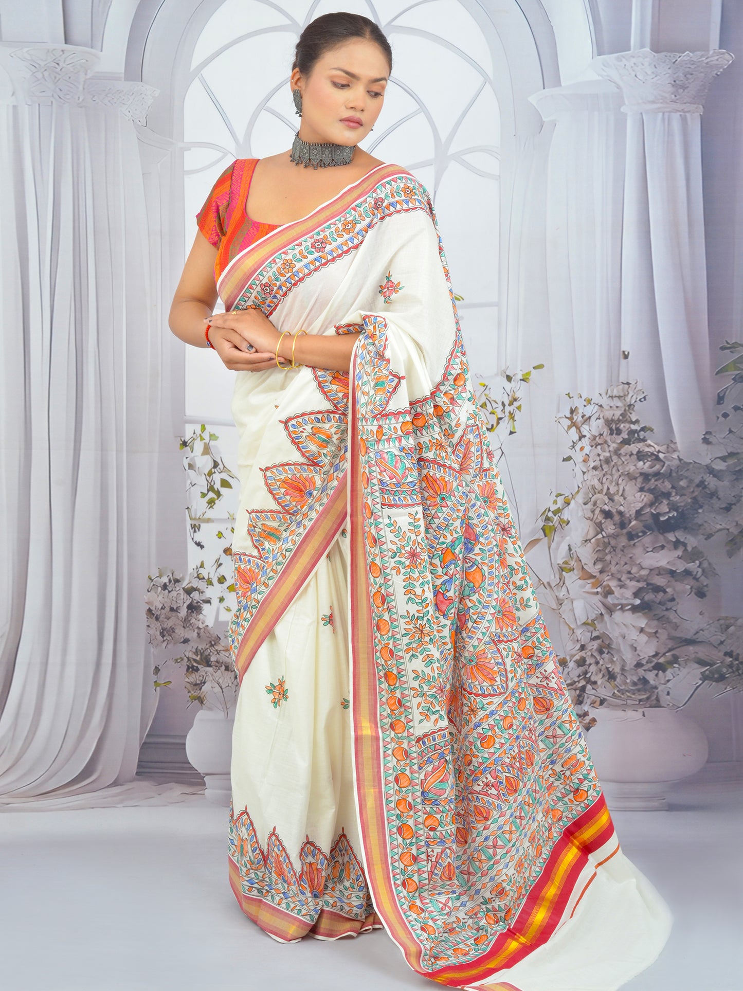 Hand-painted Madhubani floral motifs on Kerala cotton saree with red border