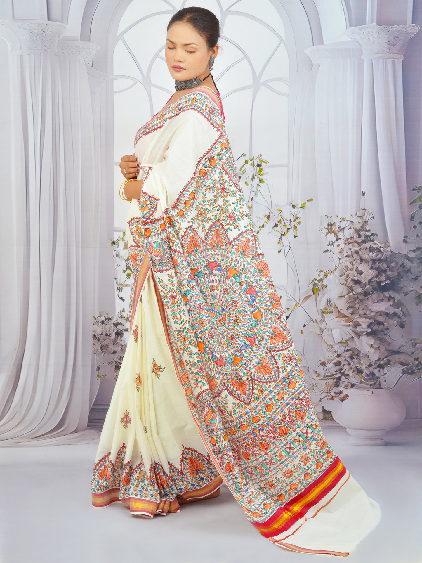 Traditional Kerala cotton saree featuring floral Madhubani art and red border