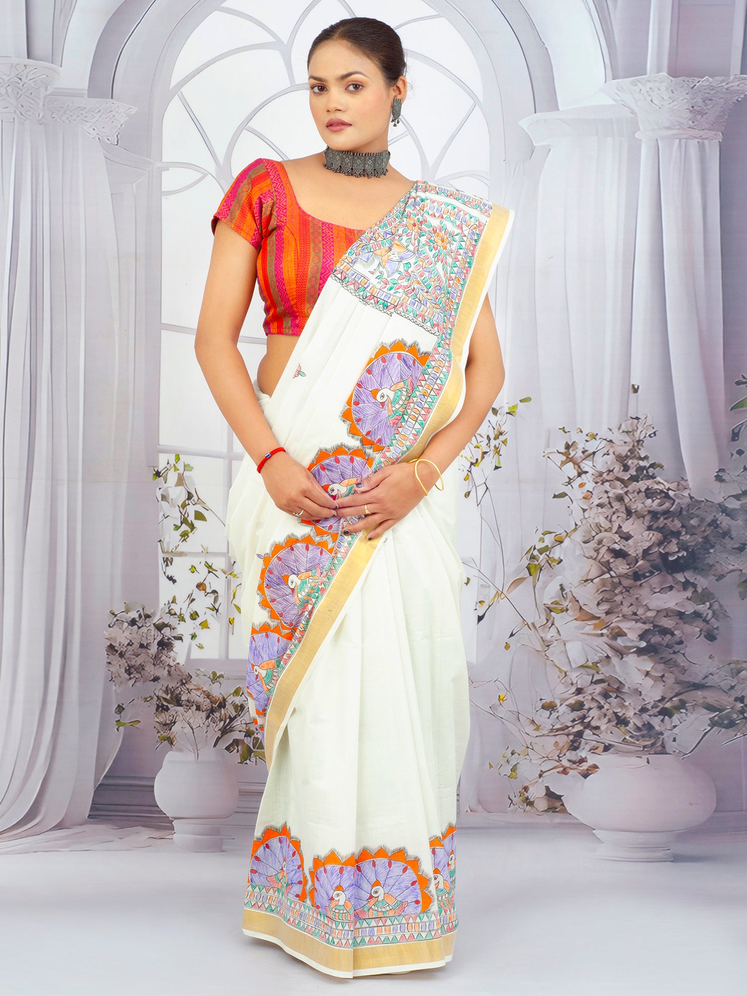 Hand-painted floral Madhubani Kerala saree with golden zari border