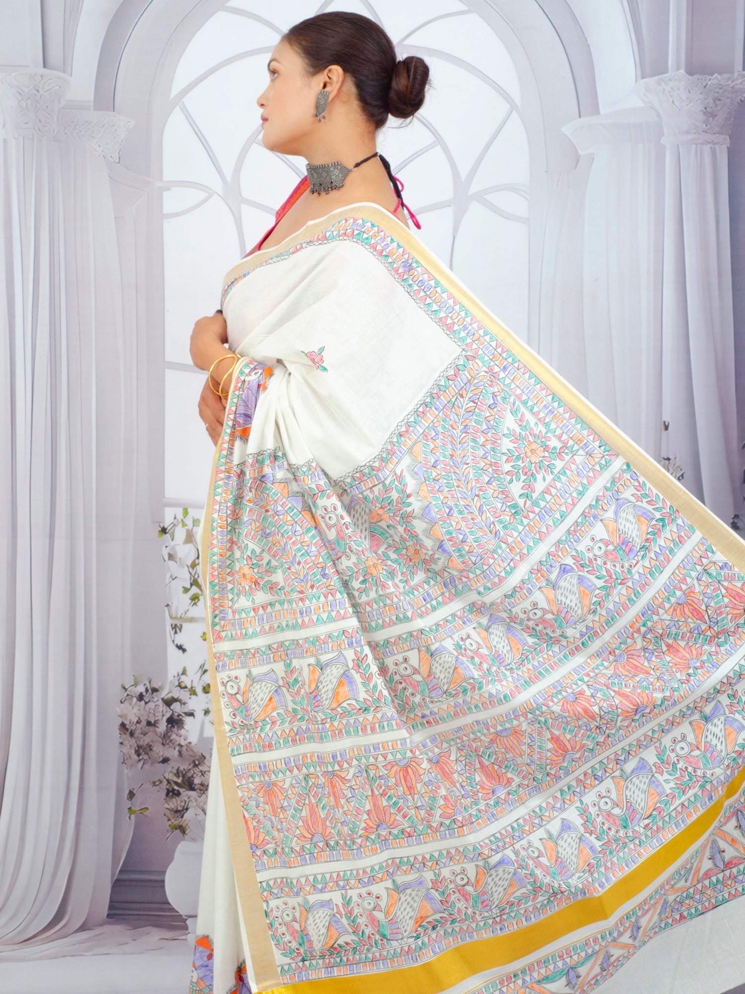 Artisan-crafted Kerala saree with floral Madhubani painting and zari border