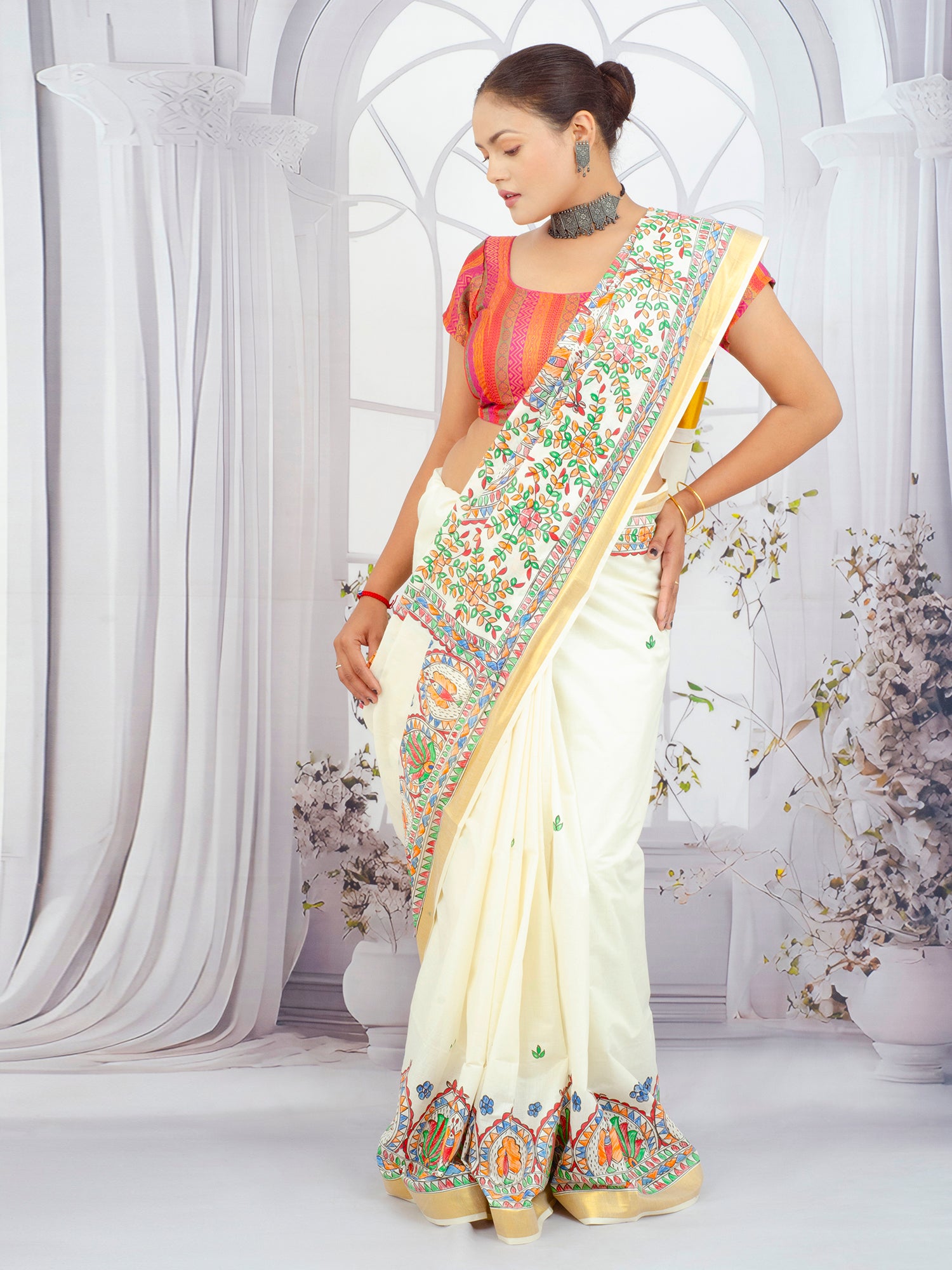 Floral Madhubani hand-painted Kerala cotton saree displayed on a mannequin