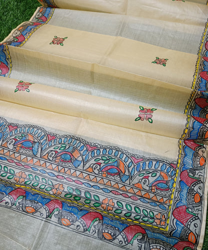 Pure off white  Madhubani Tussar silk stole featuring an extensive border of colorful hand-painted fish motifs and detailed panels of stylized birds
