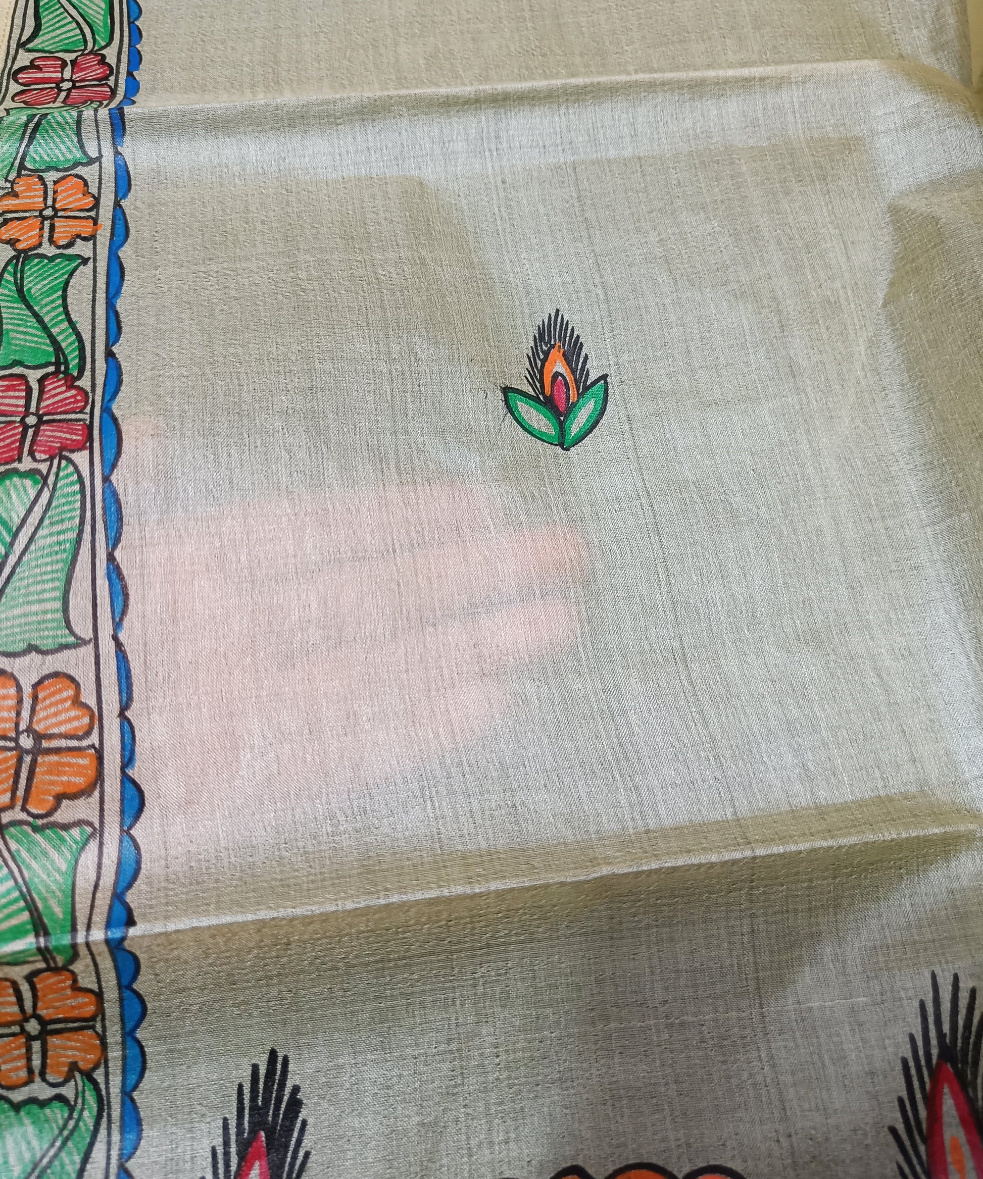 Hand-painted Madhubani Tussar silk stole with colorful traditional fish and floral motifs on a natural cream background