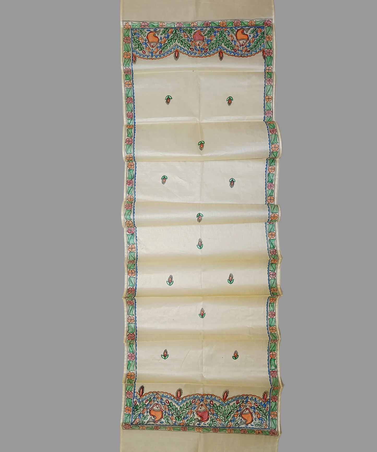 Hand-painted Madhubani Tussar silk stole with colorful traditional fish and floral motifs on a natural cream background