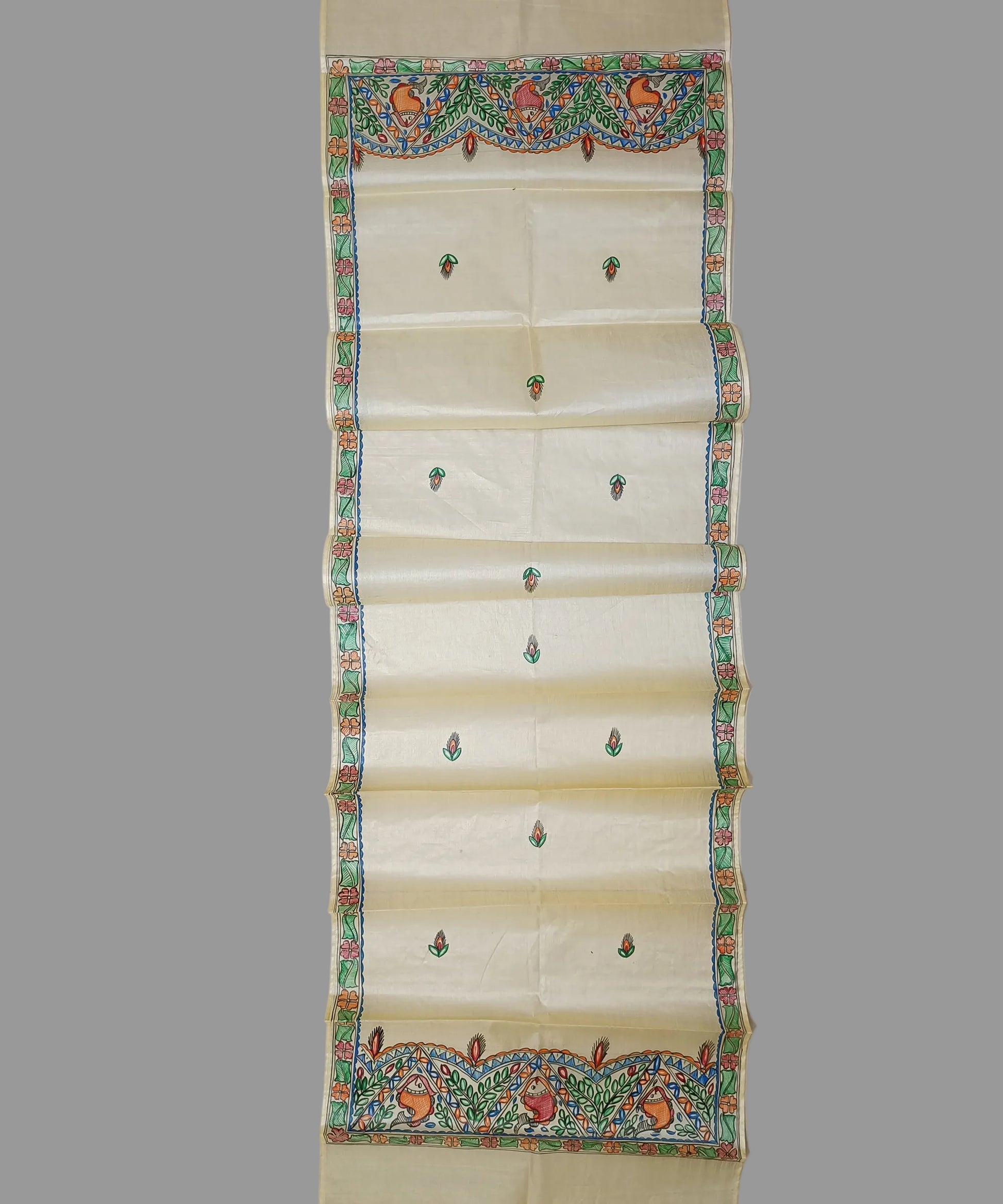 Hand-painted Madhubani Tussar silk stole with colorful traditional fish and floral motifs on a natural cream background