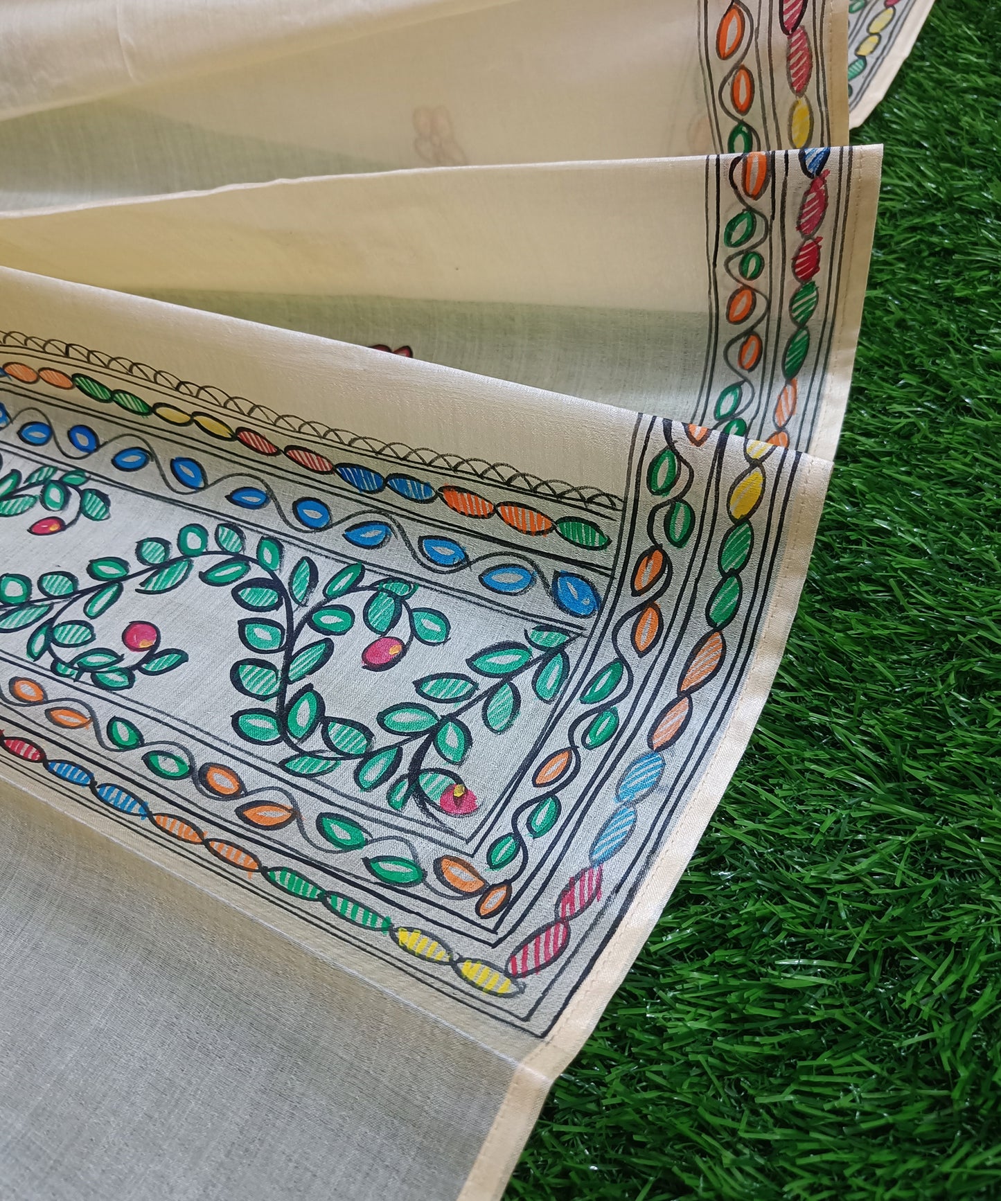 Natural cream Madhubani Tussar silk stole featuring a colorful central circular peacock motif and green leafy vine borders