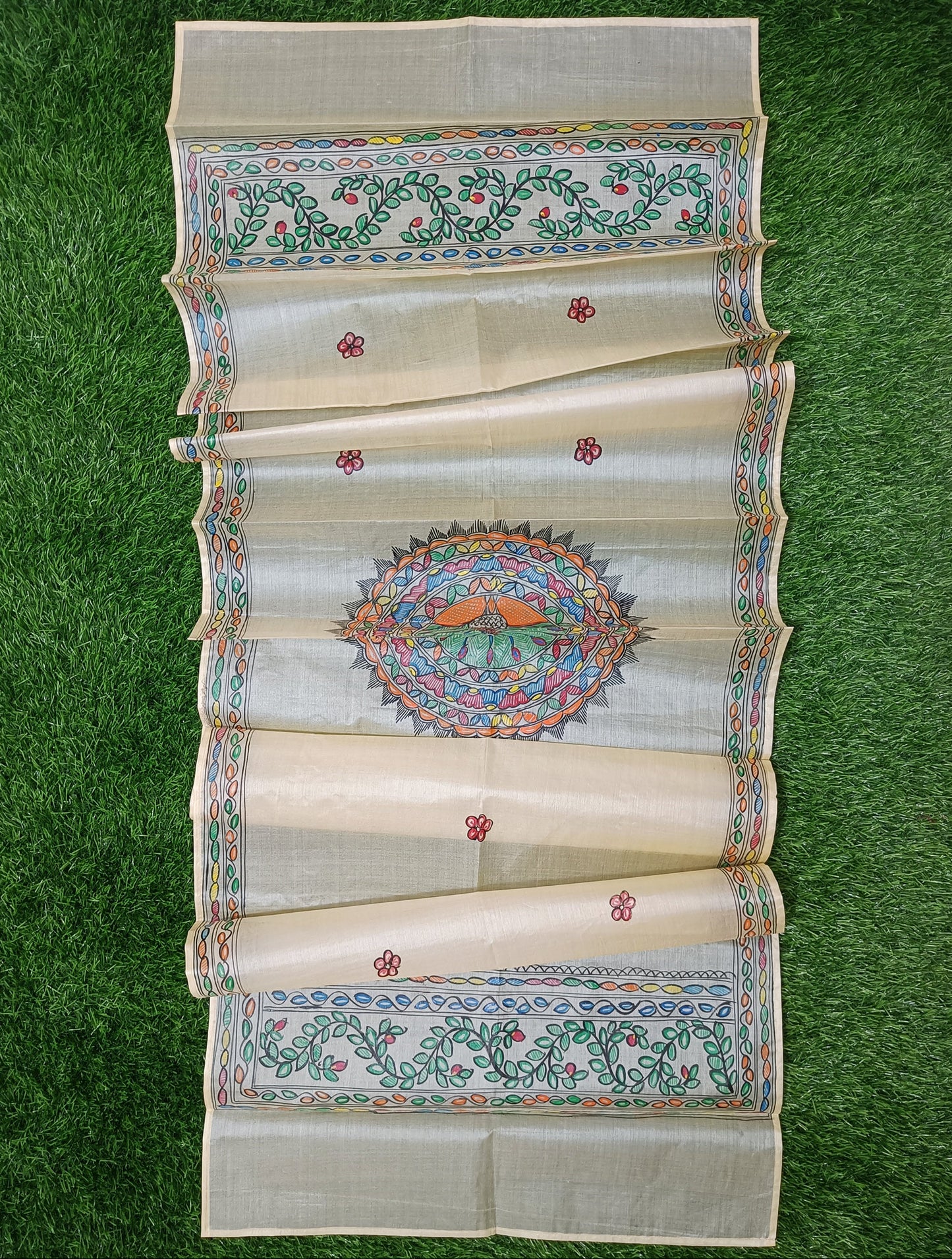 Off-white/cream Madhubani Tussar silk stole featuring a colorful central circular peacock mandala and green leafy vine borders