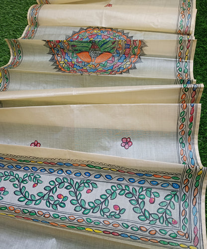 Natural cream Madhubani Pure Tussar silk stole featuring a colorful central circular peacock mandala and green leafy vine borders