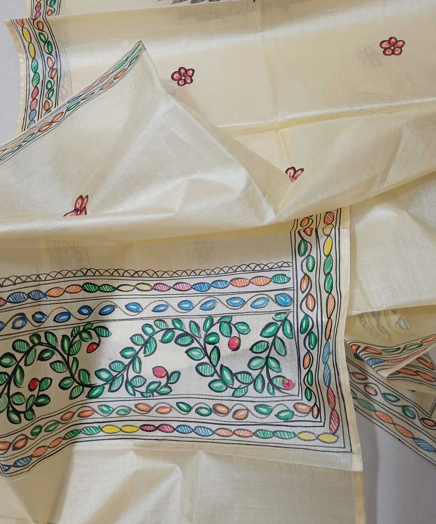 Hand painted Natural cream Madhubani Tussar silk stole featuring a colorful central circular peacock Motif and green leafy vine borders