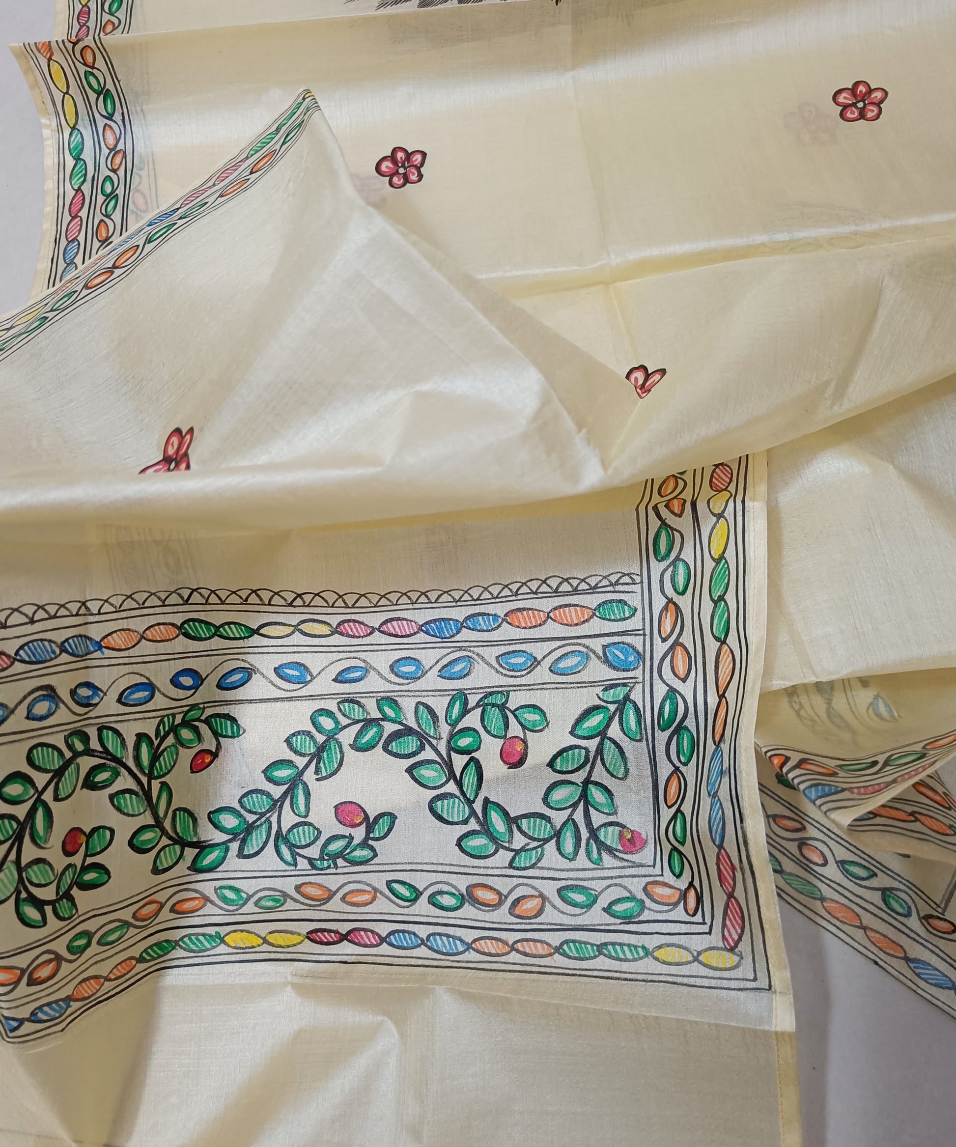 Hand painted Natural cream Madhubani Tussar silk stole featuring a colorful central circular peacock Motif and green leafy vine borders