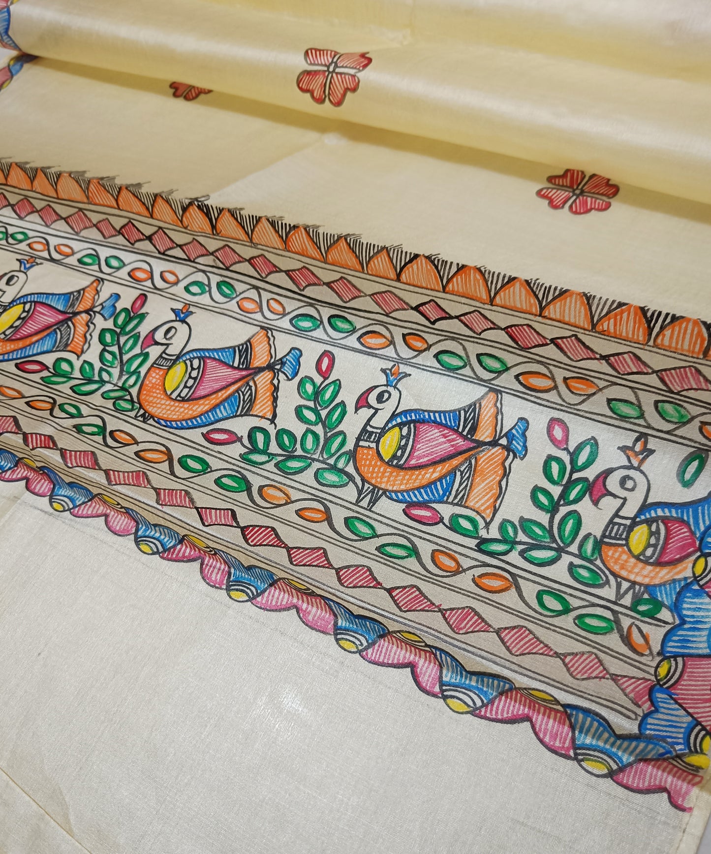 Natural beige Madhubani Tussar silk stole showcasing colorful hand-painted borders of peacocks, fish, and temple geometric patterns