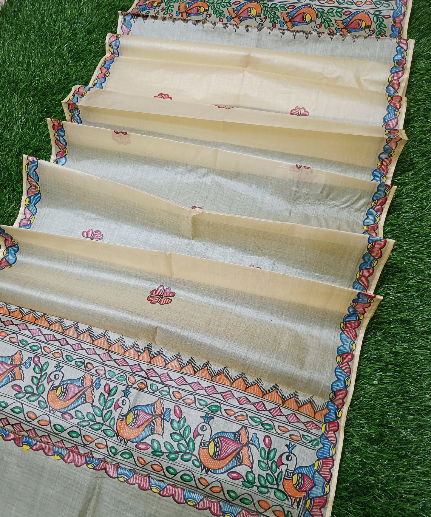 Natural beige Madhubani Tussar silk stole showcasing colorful hand painted borders of peacocks, fish, and temple geometric mithila patterns