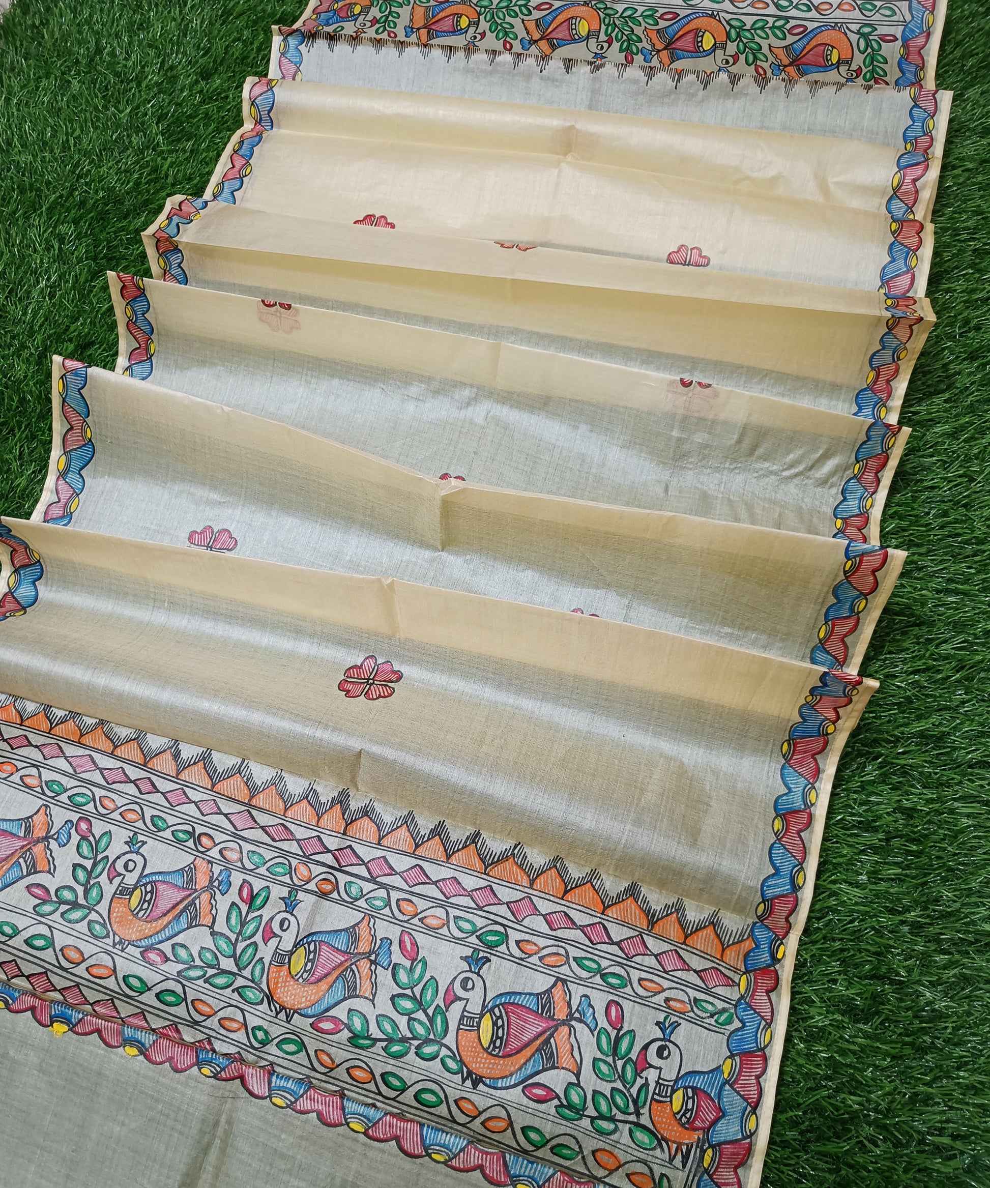 Natural beige Madhubani Tussar silk stole showcasing colorful hand painted borders of peacocks, fish, and temple geometric mithila patterns