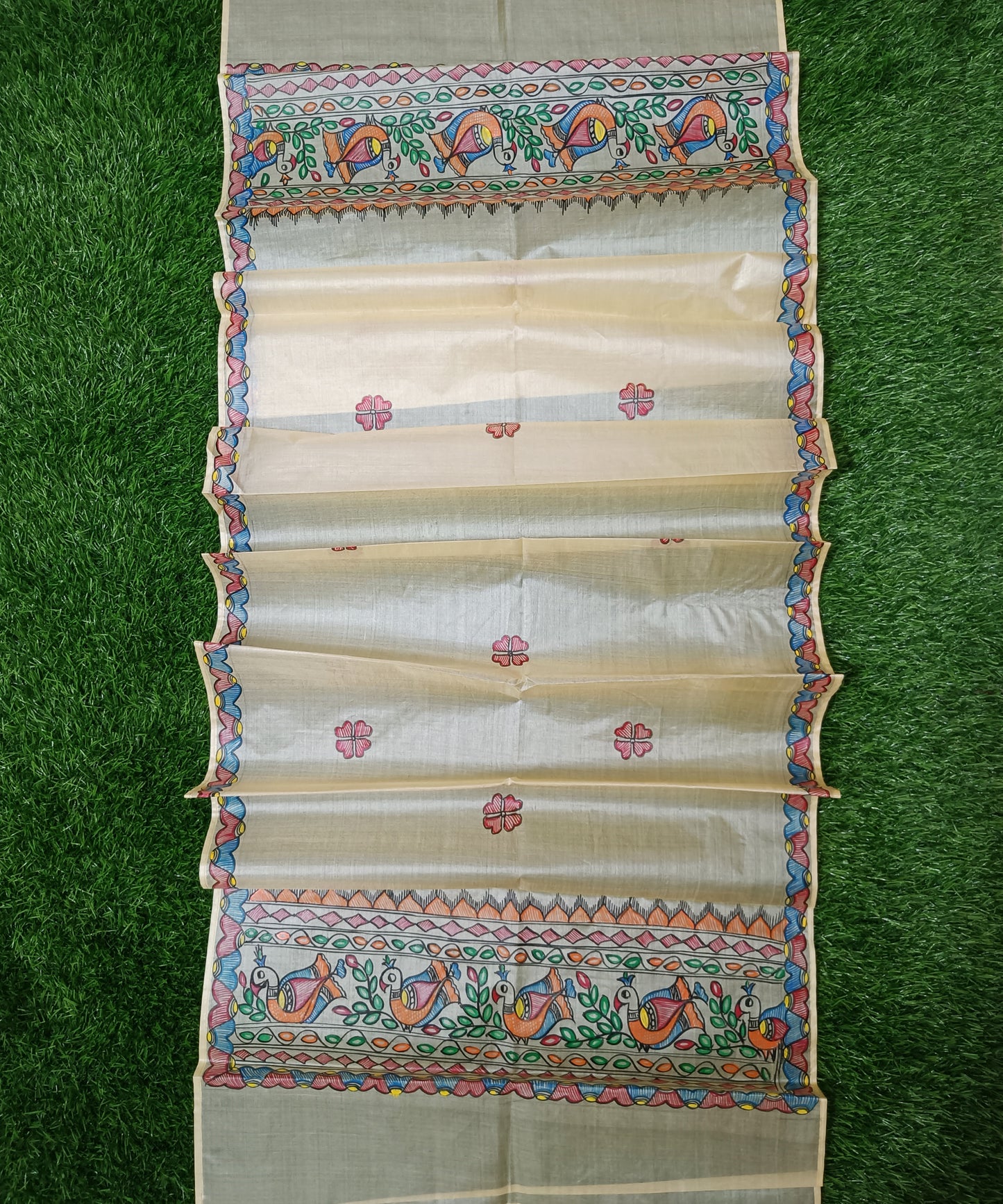 Natural beige Madhubani Tussar silk stole showcasing colorful hand painted borders of peacocks, fish, and temple geometric patterns