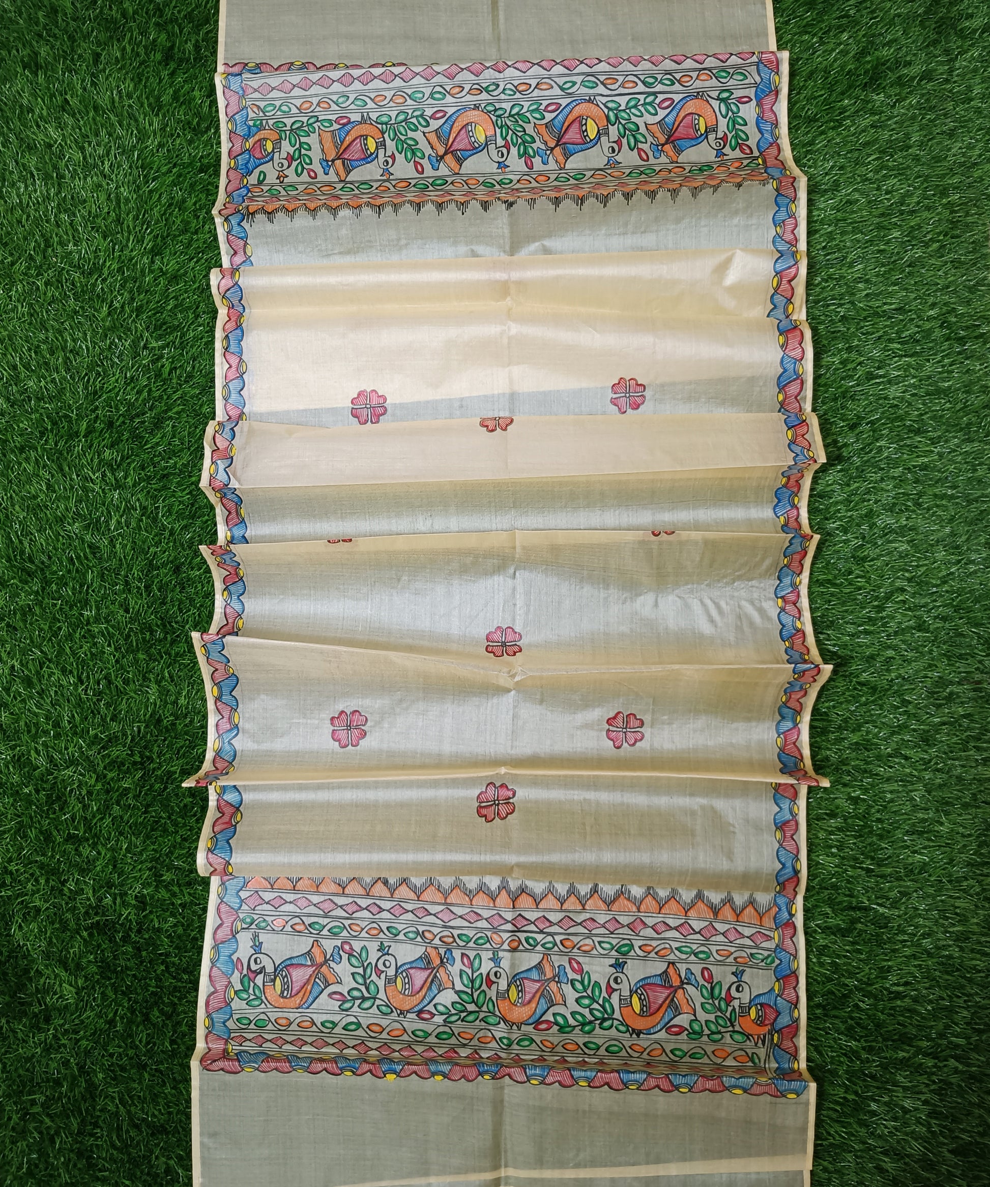 Natural beige Madhubani Tussar silk stole showcasing colorful hand painted borders of peacocks, fish, and temple geometric patterns