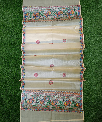 Natural beige Madhubani Tussar silk stole showcasing colorful hand painted borders of peacocks, fish, and temple geometric patterns