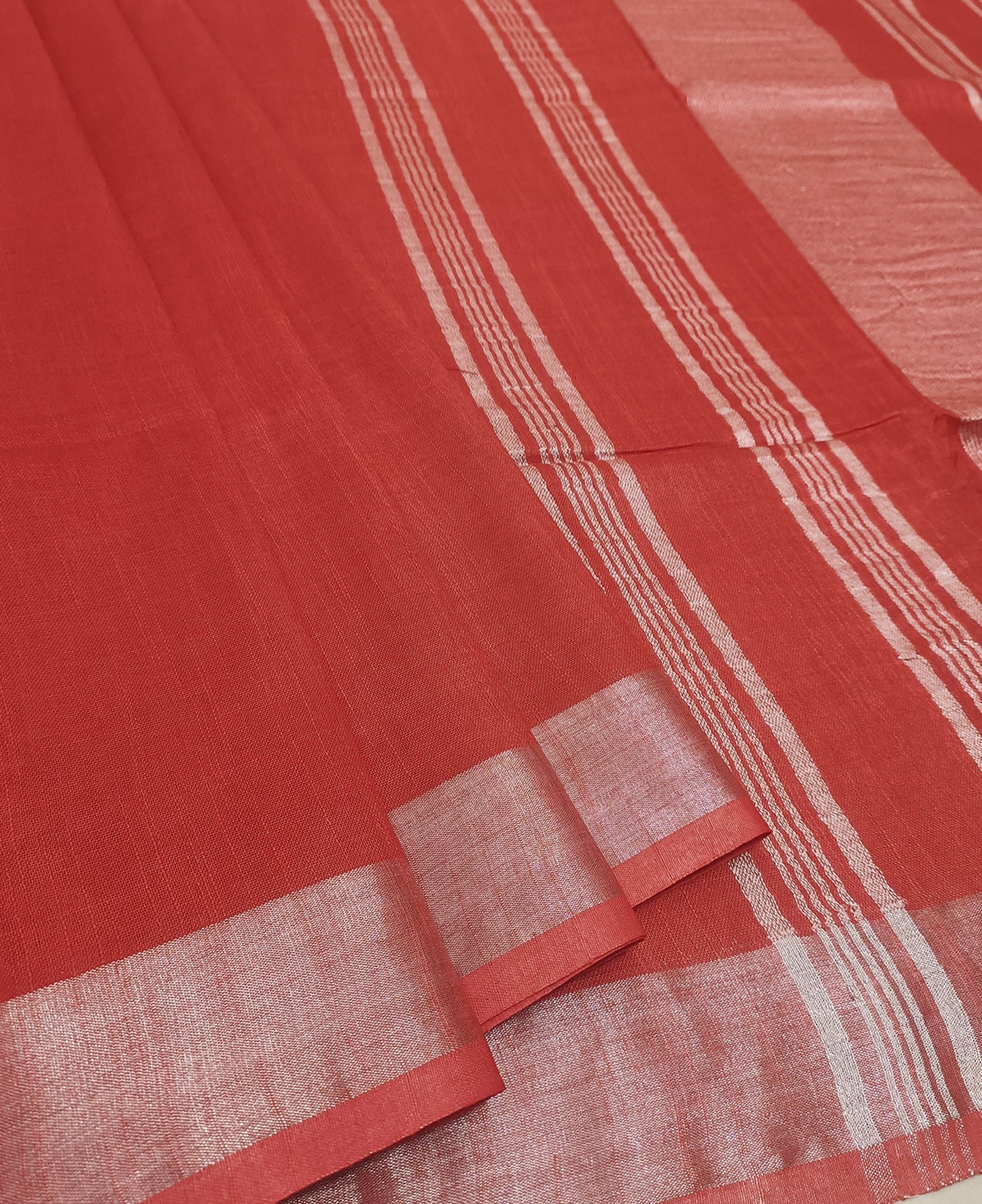 Radiant Red Cotton Slub Saree with Gleaming Silver Zari Border and White Tassels