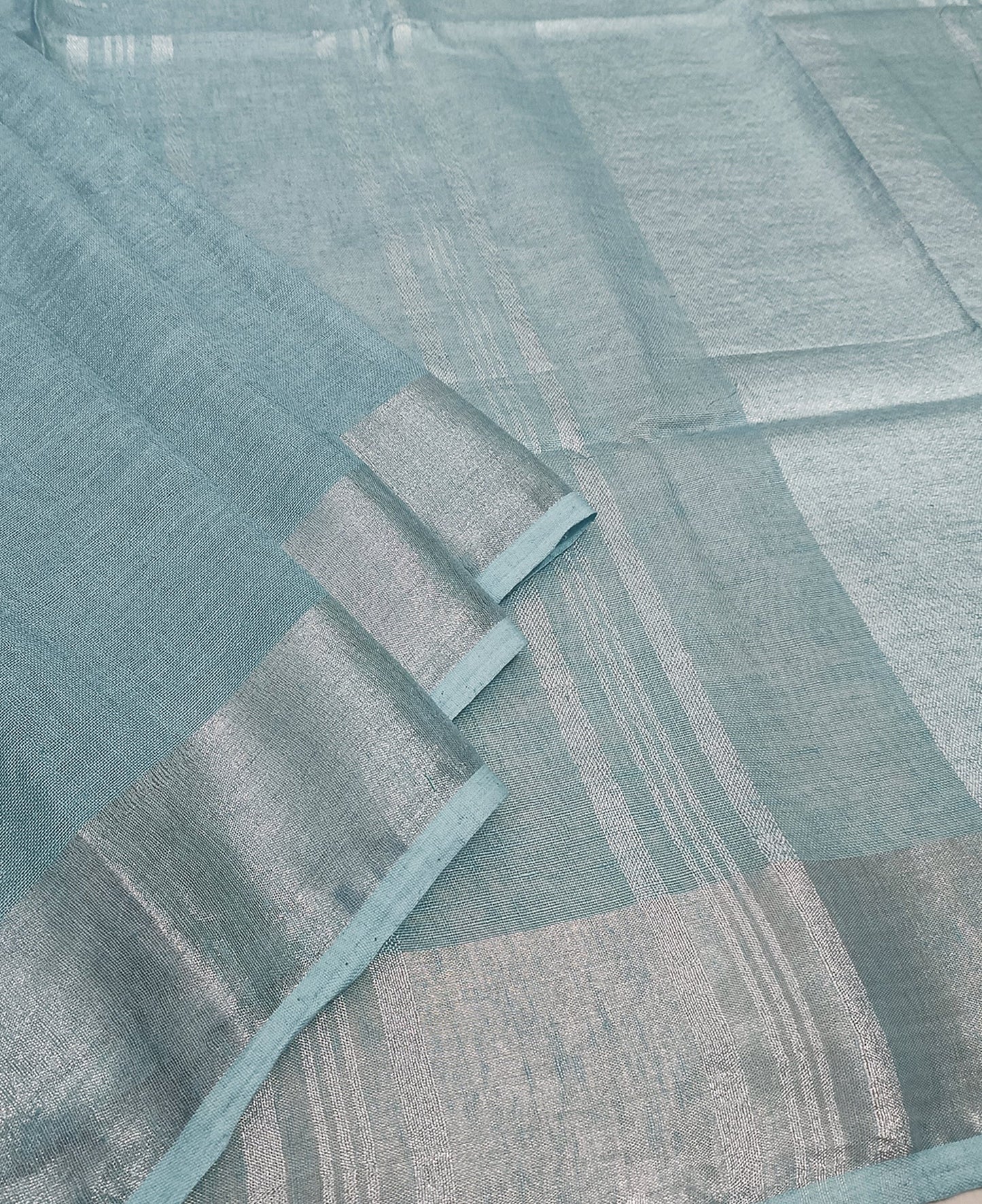 Serene Sky Blue Linen Saree with Classic Silver Zari Border and Tassel Details